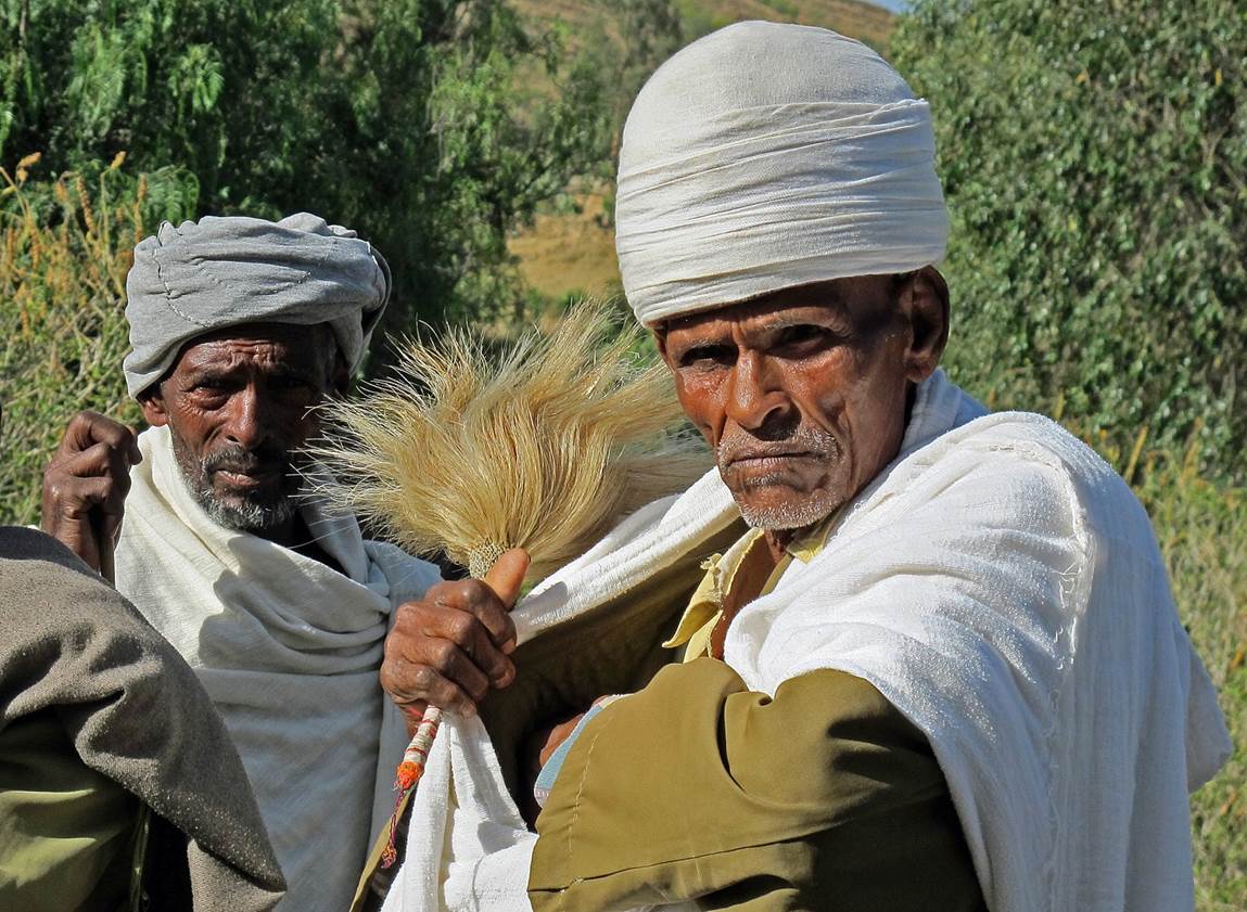 A group of men wearing white turbans

Description automatically generated