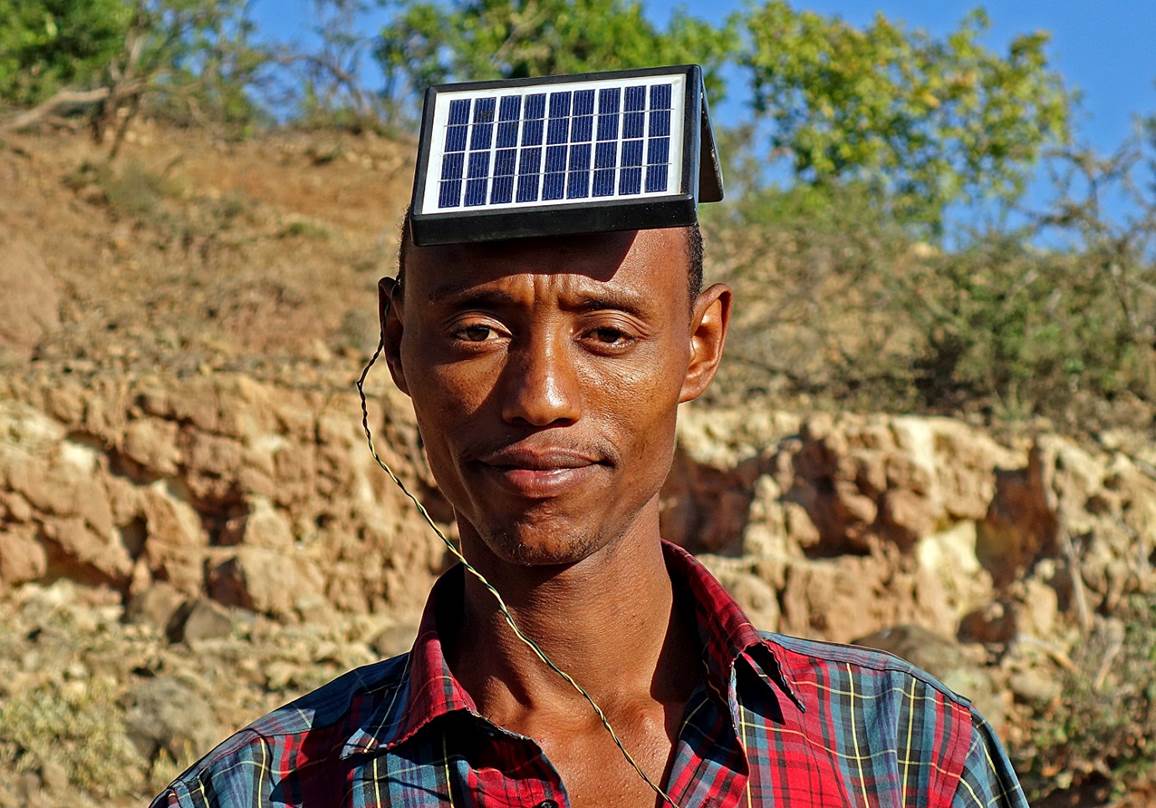 A person with a solar panel on his head

Description automatically generated