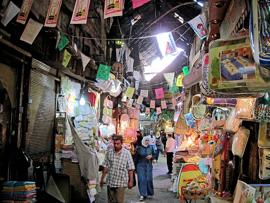People in a narrow alley with many colorful flags

Description automatically generated with medium confidence