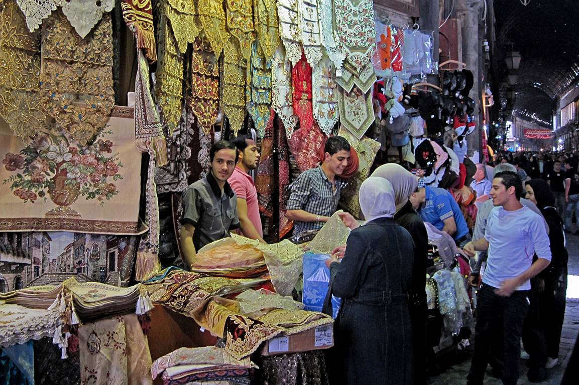 People in a market selling textiles

Description automatically generated with medium confidence