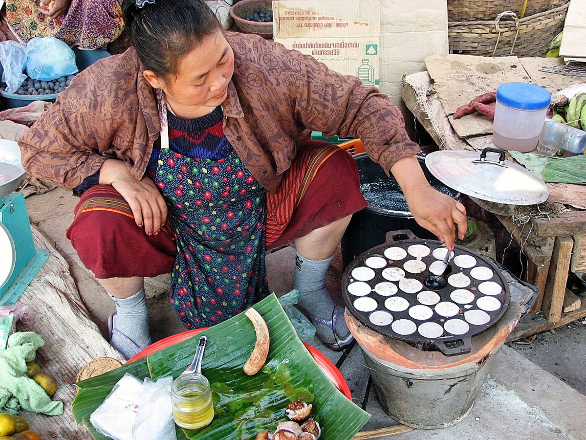 A person cooking food on a stove

Description automatically generated