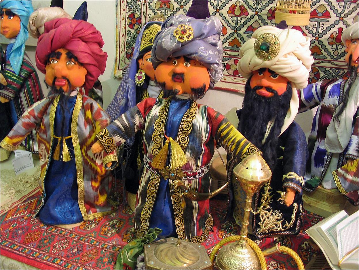 A group of puppets in turbans

Description automatically generated