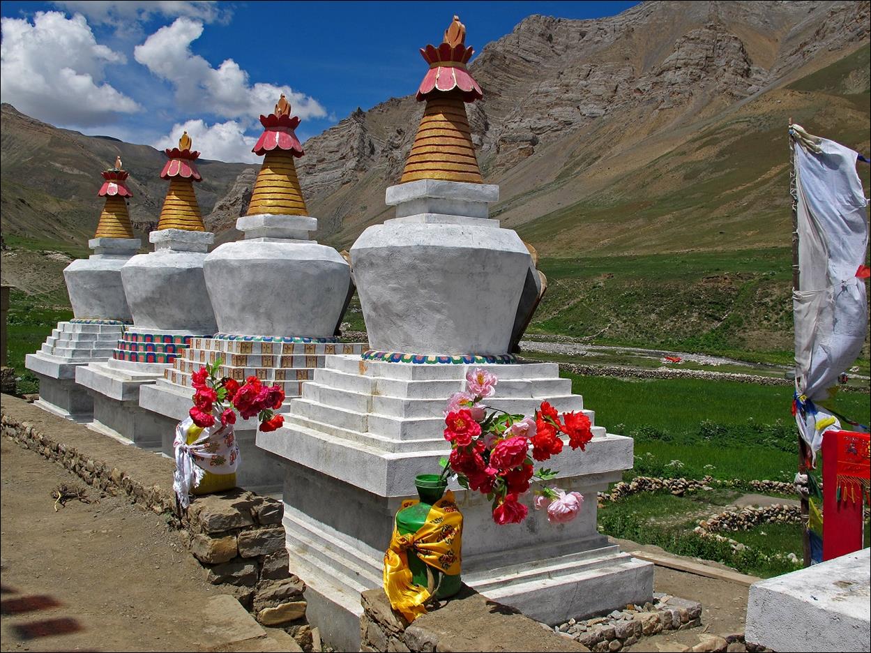 A group of white stone structures with red and yellow tops

Description automatically generated