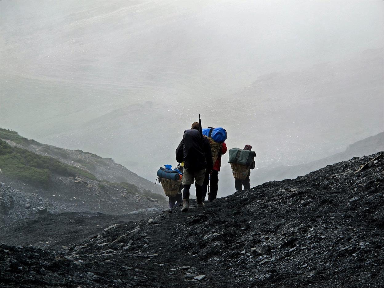 A group of people walking on a mountain

Description automatically generated