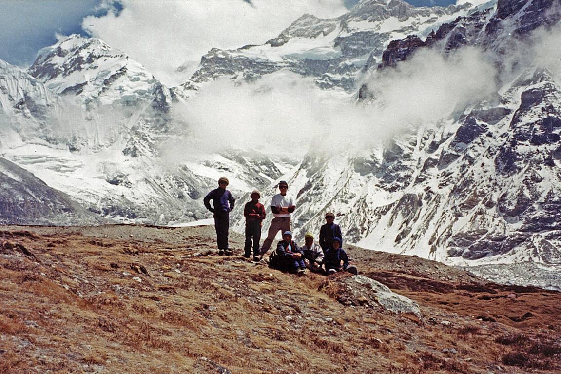 A group of people standing on a mountain

Description automatically generated