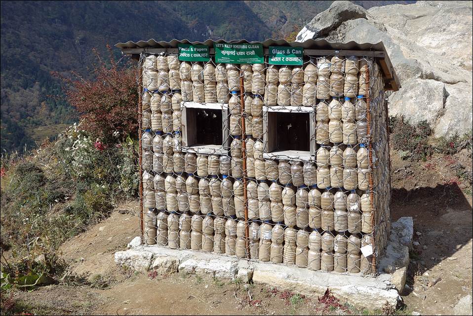 A building made of plastic bottles

Description automatically generated