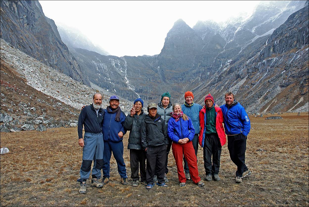 A group of people standing in a mountain

Description automatically generated