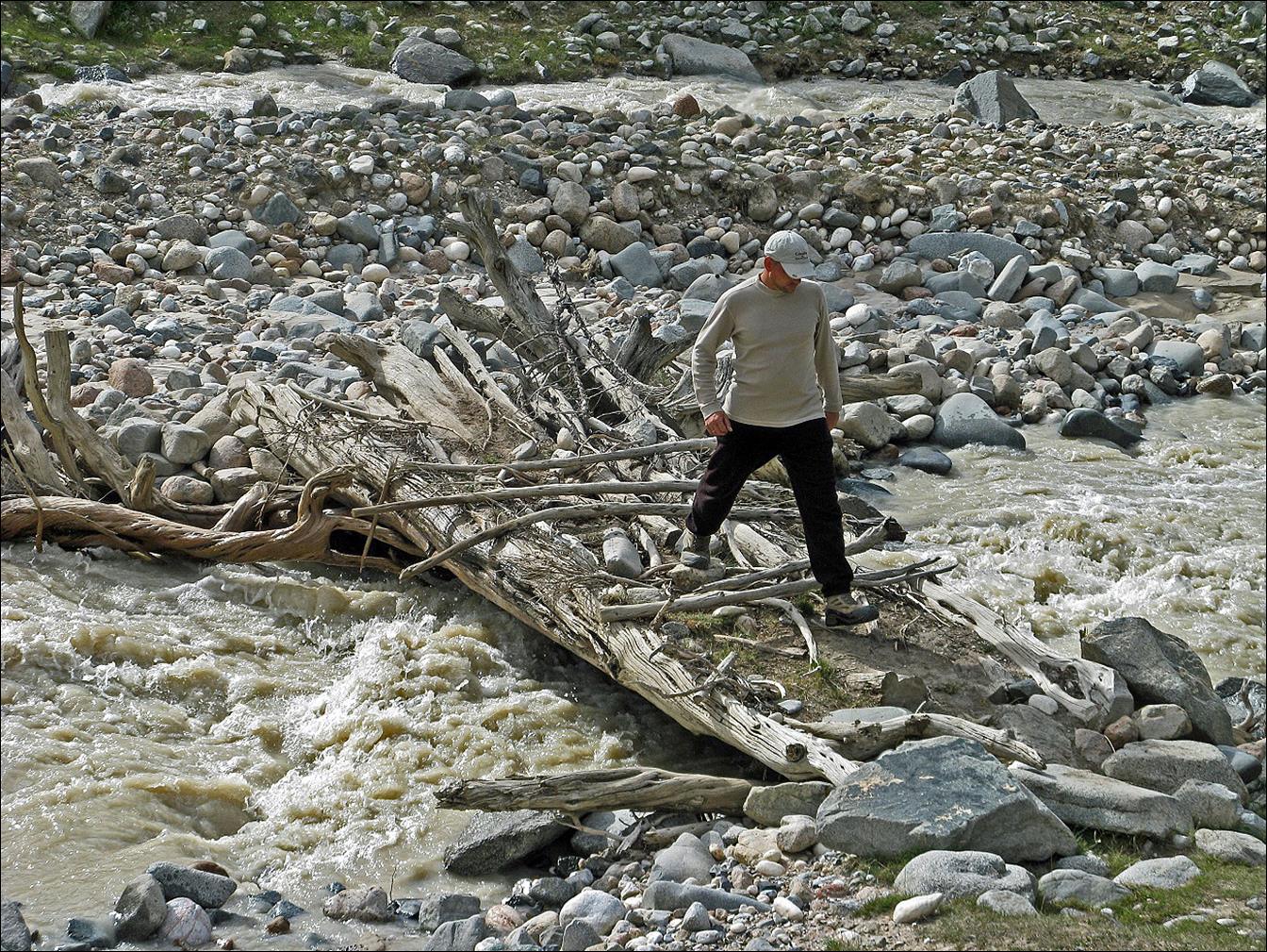 A person crossing a river

Description automatically generated