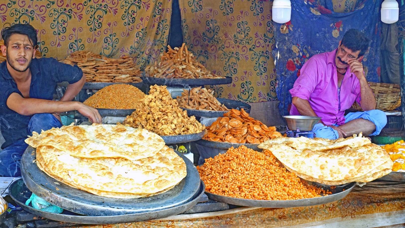 A person and person sitting next to a table full of food

Description automatically generated with low confidence