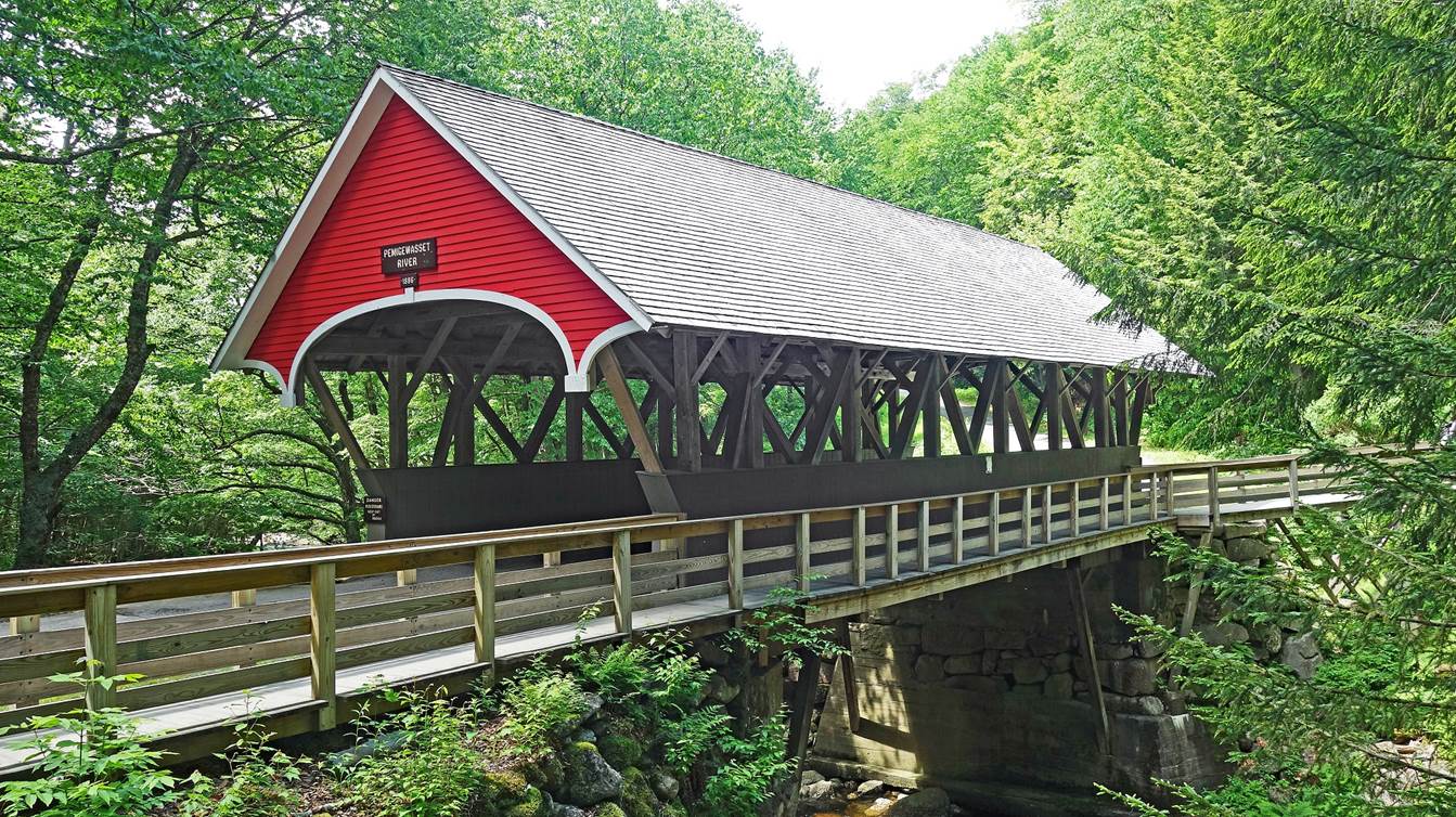 A covered bridge with a red roof

Description automatically generated with low confidence